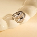 Polished silver geometric open ring in minimalist crisscross design on ceramic tray - Steel Color 146