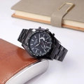 Detail of black chronograph watch featuring a tachymeter bezel and metallic strap - Black Band Black Dial