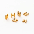 Macro shot of 1.8mm aperture gold-plated letter H beads for DIY jewelry making - Letter H / Gold