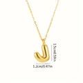 Dettaglio del ciondolo a lettera J dorata con misure di 1,5 cm per 1,2 cm - Lettera J