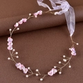 Detail of bridal headband with pink sequin flowers, pearls and golden wire work - Purple