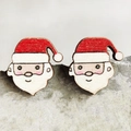 Detailed close-up of Santa Claus wooden stud earrings displayed on a grey stone texture - Santa Claus