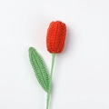 Close-up of handmade orange crochet tulip with detailed yarn texture and green stem - Finished Closed-mouth Tulip (orange)