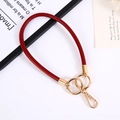 Close-up of red PU leather wristlet strap with golden spring ring and lobster clasp - Burgundy