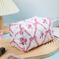 Quilted cosmetic bag with pink bow and rose floral pattern on a light wooden tray - Pink Rose Plaid