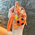 Portachiavi da calcio arancione e nero con cinturino intrecciato e ciondolo sorridente - Arancione