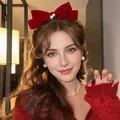 Detail of red velvet bow hair clip with central pearl accent worn with red sweater - 14# Velvet Bow Hair Clip - Red Two Pearls