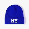 Detailed close-up of white NY embroidery on a royal blue ribbed knit beanie hat - One Size / Sapphire Blue