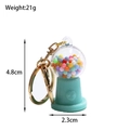 Detail shot of mint green candy machine keychain with size dimensions and 21g weight - Light Blue