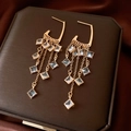 Detail of gold fringe earrings with square zircons on a luxury jewelry box - Gold (925 Sterling Silver Earring Post)