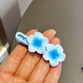Sweet blue frangipani wave hair clip for girls featuring sparkling glitter petals - Blue Plumeria