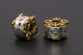 Macro shot of two-tone metal beads with vintage relief patterns and Chinese engraving - Amulet / 11x11mm