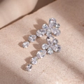 Macro shot of silver zircon flower earrings with teardrop dangles on a stone texture - Silver Pin - Silver Zirconia Water Drop Earrings