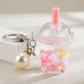 Detail of liquid-filled bubble tea keychain with pink sequins and large white pearl - Lobster Clasp Chain + Mini Milk Tea Cup + Pearl / Pink