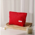 Minimalist red corduroy makeup bag for travel storage on a stylish wooden tray - Red