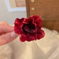 Elegant deep red fabric flower hair clip accessory held by hand for a realistic size look - Small Camellia Hair Claw Dark Red