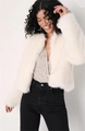 Detail of soft white faux fur jacket texture paired with a sparkling sequin top - S / Milky White