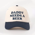 Close-up of DADDY NEEDS A BEER navy blue embroidery on a cream cotton baseball cap - Adjustable / Cream/Navy Blue