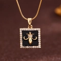 Gold tarot necklace with black square pendant featuring a golden fleur-de-lis emblem - Gold (X6063GD)