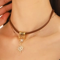 Detailed view of a double-layered brown leather choker with gold starburst pendant - Double Layer Star Necklace (11 Gold 0912)