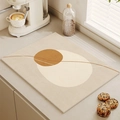 Absorbent kitchen drying mat with caramel geometric patterns on a grey countertop - Geometric