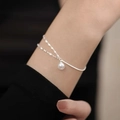 Detailed view of layered silver-toned chain bracelet with pearl on wrist - Silver Pearl Snake Wave Set (MY36442)