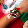 Detailed view of Christmas charm bracelet with Santa, bell and star pendants on wrist - Star Pom Pom Style(27664-colour)