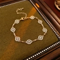 Detailed close-up of a hollowed rhombus cloud bracelet on dark green velvet background - Hollow Lucky Cloud Bracelet / Bracelet - Gold