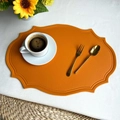 Orange oval faux leather placemat with decorative stitching on a white background - Yellow Faux Leather Vintage Oval