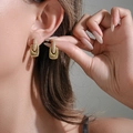 Elegant gold square stud earrings with pave crystals worn by a model - Gold Stud Earrings (254)