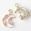 Detailed view of gold moon charms with pink resin gradient and white zircon accents - Gold Base Pink