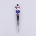 Close-up of beaded ballpoint pen with Patriotic Faith Family Freedom silicone heart charms - USA Flag