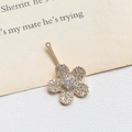 Macro shot of gold floral pendant featuring sparkling white cubic zirconia micro-pave - 1# Five-Petal Flower