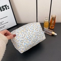 Quilted cotton makeup bag in white with blue floral pattern and soft handle grip - Blue Floral
