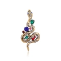 Close-up of vintage snake brooch featuring colorful rhinestones and gold-tone metal texture - Treasure Snake Gold
