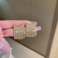 Close-up of golden fringe earrings featuring geometric metal chains and luxury tassels - Gold Arc Round (29# Silver Needle)