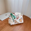 Detailed close-up of small quilted cotton pouch with cute bear patterns and green zipper cord - Candy Bear Quilted