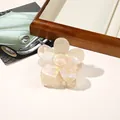 Detailed shot of pearlescent flower claw clip in iridescent acrylic material - PVC 7cm Flower - Iridescent Yellow