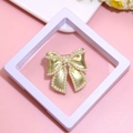 Elegant golden bow brooch with white pearls displayed on a minimalist pink background - XZ104-Gold Bowknot-Boxed