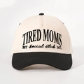 Close-up of Tired Moms embroidery on a two-tone beige and black cotton baseball cap - One Size / Cream/Black