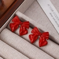 Elegant red bow stud earrings with diamond accents and a polished finish for women - Red