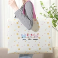 Large non-woven gift bag with floral cat print and pink handles shown with model - Three Kittens / Horizontal 27*32*10cm