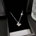Close-up of double butterfly pendant necklace with glitter finish in a black jewelry box - Silver (H317)