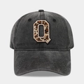 Detailed view of the leopard print Q embroidery on dark grey washed denim baseball cap - Letter Q