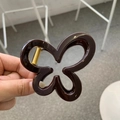 Deep brown flower-shaped hair claw clip with glossy finish and durable gold metal spring - Chocolate
