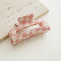 Detail of pink and cream checkerboard hair claw clip on stone textured base - Hollow Pink
