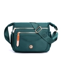 Dark green multi-pocket nylon crossbody bag with gold zippers and adjustable shoulder strap - Post Blue