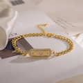 Detailed macro shot of golden Cuban chain bracelet with heart-shaped cubic zirconia charm - Heart Style