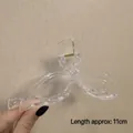Transparent bow-shaped hair claw clip made of acrylic with 11cm length shown in hand - Glossy Clear Bow-11cm