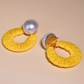 Detailed view of yellow raffia woven hoop earrings featuring large white faux pearls - Yellow Pearl Decorated Woven Large Hoop Drop Earrings